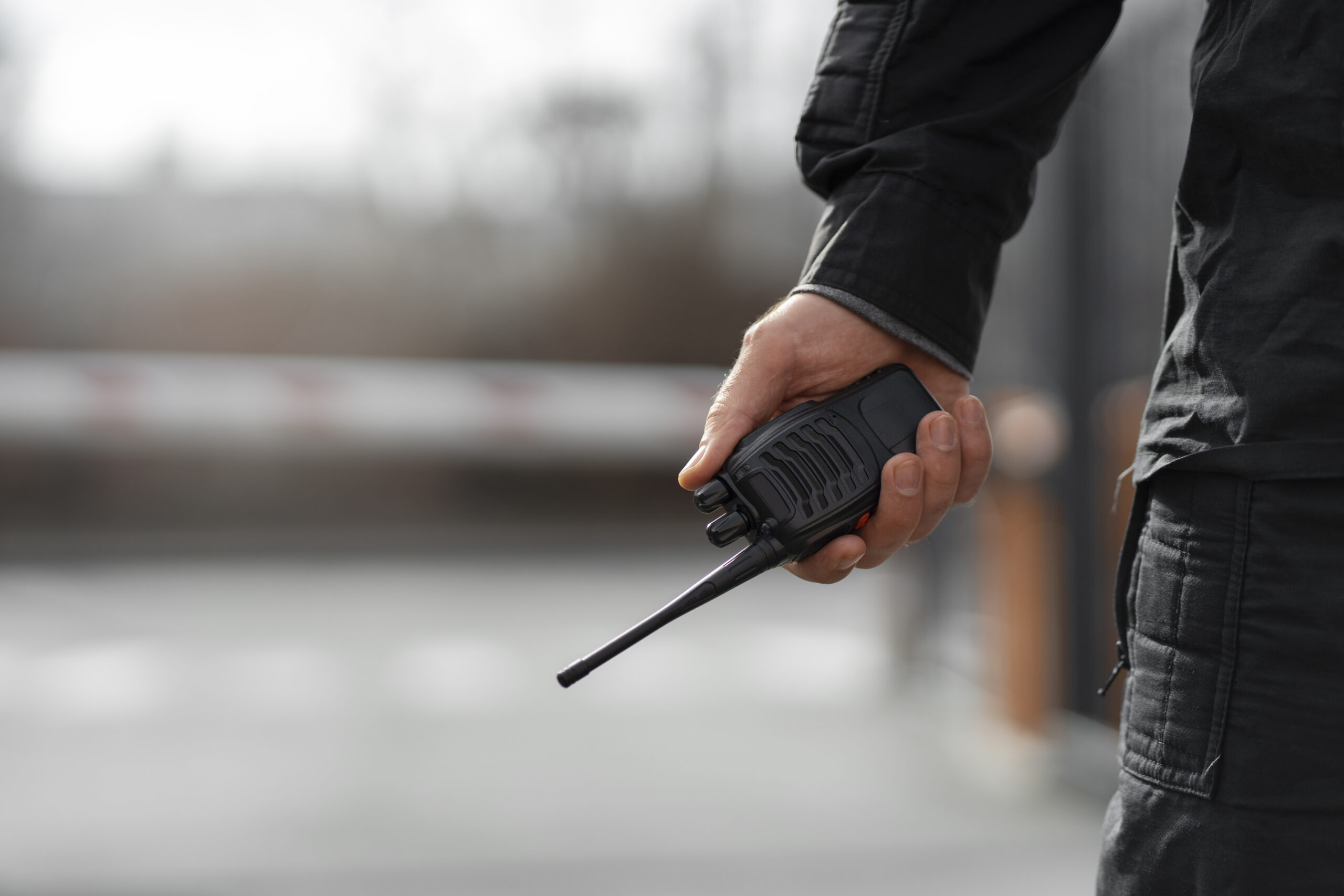 Security officer holding a two-way radio