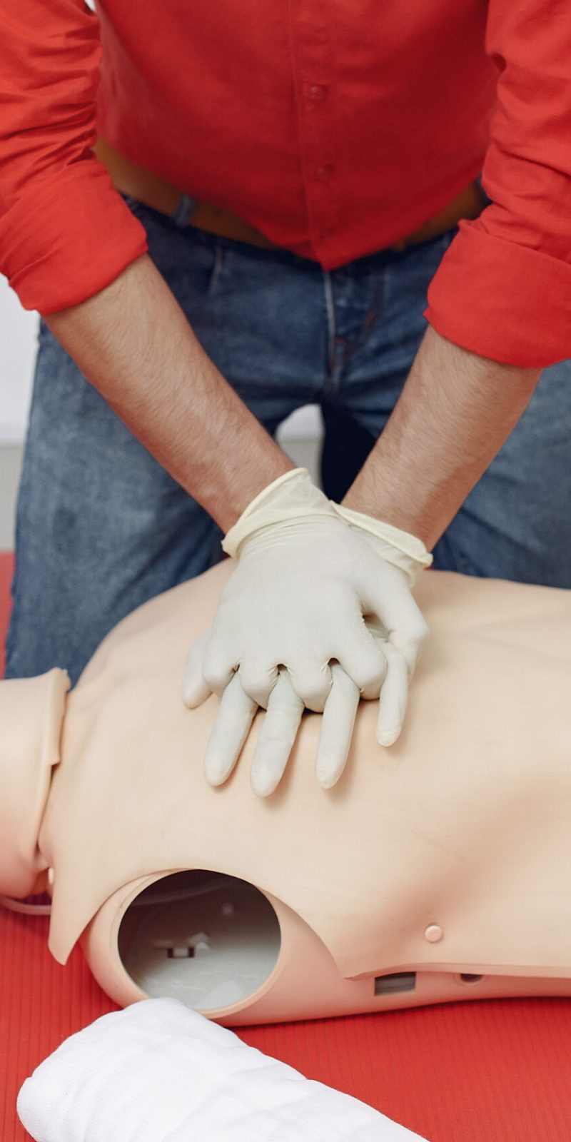 Medical student are practicing. Man provide first aid. Doctor in medical gloves performs resuscitation.